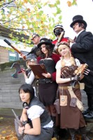 Elsa (bottom centre) as Miss Amelia Evelyn Hawkesworth - an original Steampunk creation - from the novel Flight Of The Valkyrie, find it on the profile of deviantart user sjbonnar